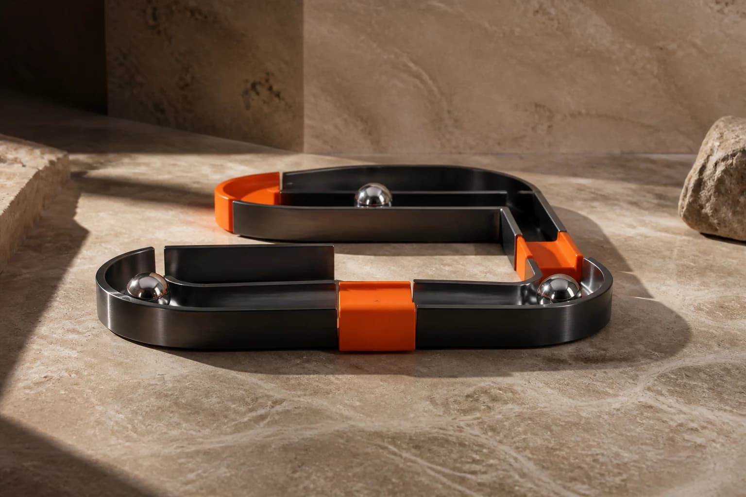 A physical metal-and-orange sculpture representing connected handoffs